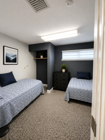 Shared bedroom with two twin beds and dresser
