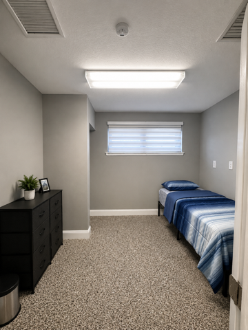 Single bedroom with dresser and window